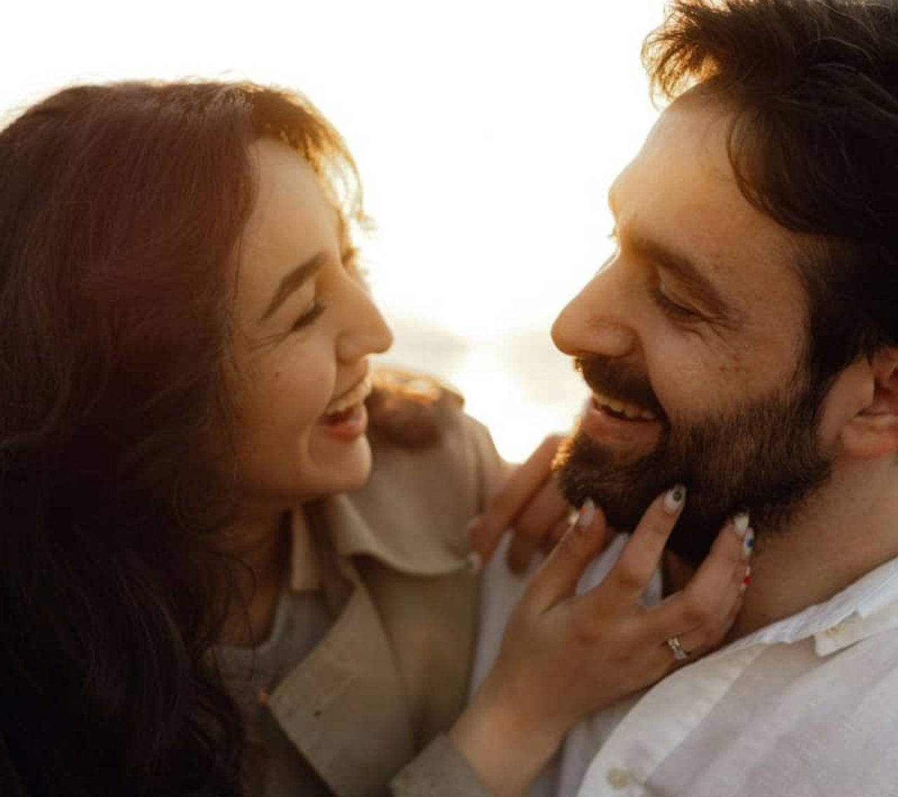 Couple smiling in warm sunset light